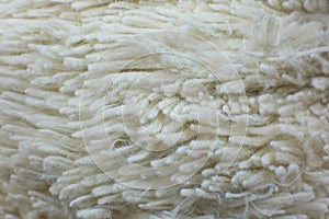 White cotton towel or carpet.fluffy texture background. Close up, macro photo. Soft focus image