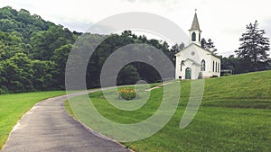 White Country Church on a Grassy Hillside