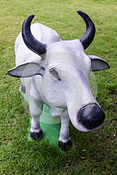 White cow statue in lawn