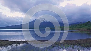 White Cranes and Arenal Volcano at Arenal Lake, Costa Rica. Aerial dro