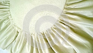White cream fabric background with folds. Sample garment from beautiful furniture Velor premium quality. Gentle light pastel beige