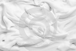 White cream foam texture background. Cosmetic mousse, cleanser, shaving foam, shampoo lather photo