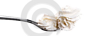 White cream on a spoon isolated on white