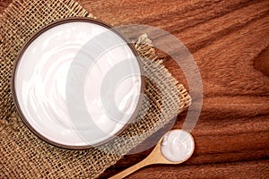 White creamy homemade yogurt on the wooden table , top view or o