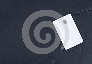 White credit card on a dark background