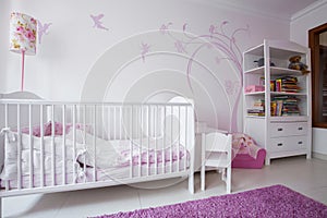 White crib in cozy nursery