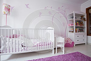 White crib in cozy nursery photo