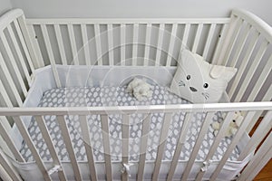 White crib and light gray walls for baby`s room