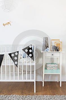 White crib and nightstand