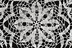 White crochet lace on black background