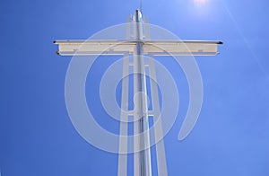 White cross in blue sky background