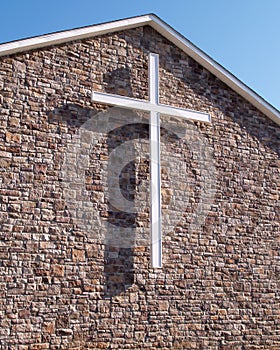 White cross on stone church building