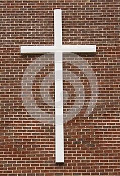 White crucifix on brick wall