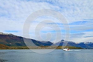 White cruise ship cruising the Beagle channel in early autumn, Ushuaia, Tierra del Fuego, Argentina