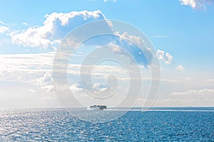 White cruise ship at sea on a sunny day.