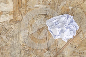 White Crumple paper ball on old wood table