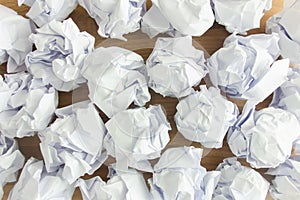 White crumpled paper balls lying on desk