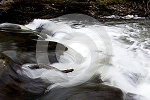 White crystal clear river stream rushing over rocks