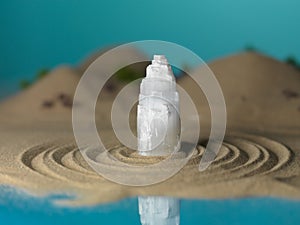 White crystal in miniature sea shore landscape