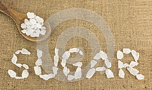 White crystalline sugar arrange as word sugar on brown
