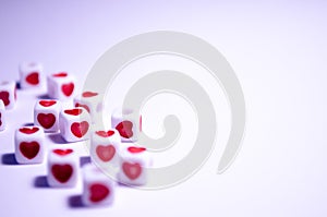 White cubes with red hearts. The 14th of February. White background and cubes side view. Dice beads. White background