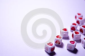 White cubes with red hearts. The 14th of February. White background and cubes side view. Dice beads. White background