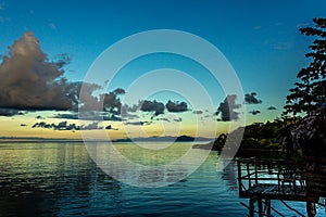 White Cumulostratus or Cumulus clouds over a lagoon on Samoa