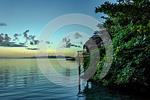 White Cumulostratus or Cumulus clouds over a lagoon on Samoa