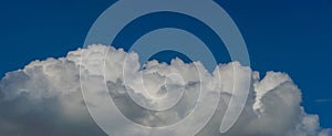 White cumulus clouds against the blue sky