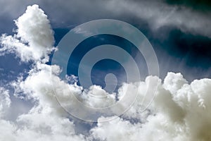 White cumulus clouds on a blue sky.