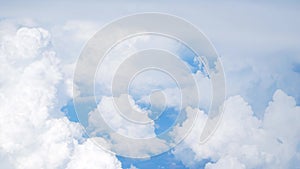 White cumulus clouds, blue sky can be seen through a dense layer of clouds. Clouds top view.