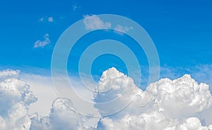 White cumulus clouds in the blue sky, illuminated by the bright spring sun.