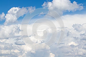 White cumulus clouds in the blue sky, illuminated by the bright spring sun.