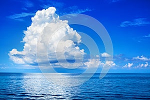 White cumulus clouds in blue sky over sea landscape, big cloud above ocean water panorama, beautiful seascape, cloudy weather