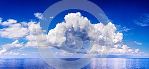 White cumulus clouds in blue sky over sea landscape, big cloud above ocean water panorama, seascape panoramic view, cloudy weather