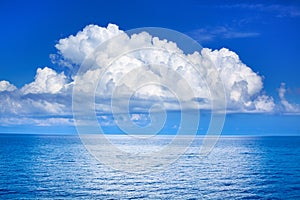 White cumulus clouds in blue sky over sea landscape, big cloud above ocean water panorama, seascape panoramic view, cloudy weather