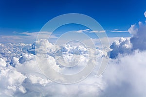 White cumulus clouds on clear blue sky background closeup, overcast skies backdrop, fluffy cloud texture, beautiful cloudscape