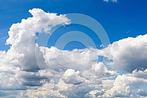 White Cumulus Clouds And Grey Storm Clouds On Blue Sky