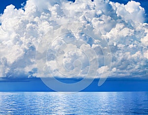 White cumulus clouds over sea close up blue sky background landscape, big fluffy cloud above ocean water panorama, cloudscape