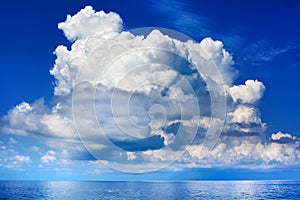 White cumulus clouds over sea close up blue sky background landscape, big fluffy cloud above ocean water panorama, cloudscape