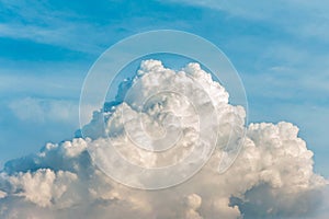 White cumulus congestus clouds on blue sky background.