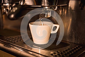 White cup being filled with decaf coffee in a cafe