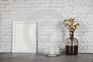 White cup with black coffee and grains of coffee in a bottle on a background of gray stone. Place for text. Mock up vintage concep