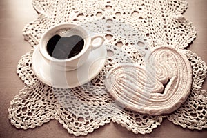 white cup of black coffee and a sweet buttery cookie on the table