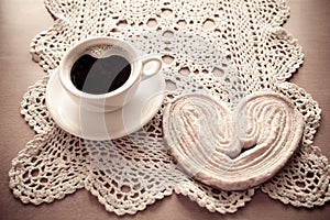 white cup of black coffee and a sweet buttery cookie on the table