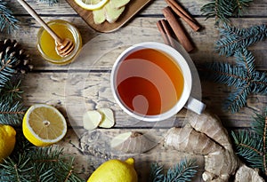 White cup of black natural tea with ginger, lemon and honey. Healthy drink. Hot winter beverage concept.