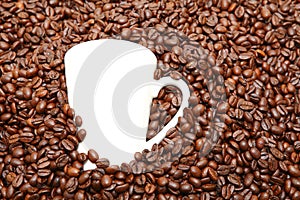 White cup in coffee beans