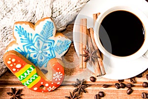 White Cup with coffee and christmas gingerbread . Christmas Food decor on wooden background. The view from the top