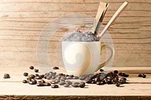 the white cup of coffee and coffee beans seed with broen sugar a