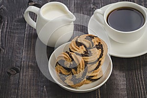 white cup about coffee and cookies against a dark background/white cup about coffee and cookies against a dark background. Top